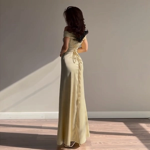 Detailed corset-style lace-up back on a yellow satin off-the-shoulder evening gown