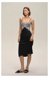 Detail of the elegant black satin nightgown with delicate white lace V-neckline patchwork