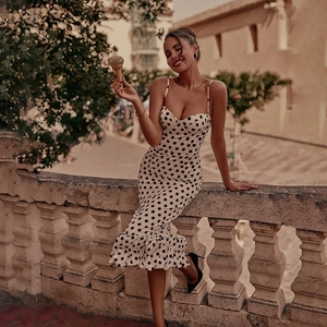 Detailed view of the elegant polka dot pattern and ruffled mermaid hemline of the dress