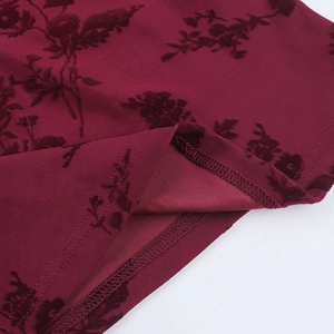 Detail view of burgundy flocked floral fabric with professional overlock hem stitching