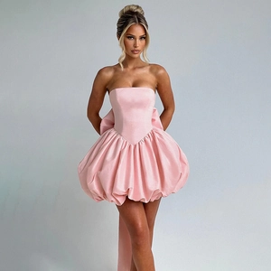 Detail of light pink bubble hem mini dress with a large oversized bow on the back