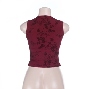 Close-up of burgundy floral cropped tank top with delicate velvet texture and slim fit