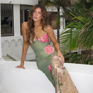 Detail of green mesh slip dress featuring large pink floral and baroque scroll patterns