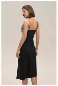 Detail of black satin nightgown showing delicate cream lace panels and smooth silk texture