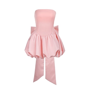 Detailed back view of pink strapless mini dress with large decorative bow and long ribbons