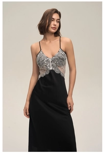 Close-up detail of delicate white lace trim on a black satin nightgown with V-neck
