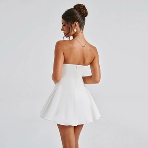 Detail view of the back of a white strapless A-line dress with a sleek invisible zipper