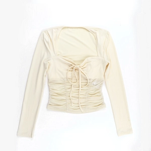 Close-up of slim fit long sleeve top featuring square neck and ruched mesh waist detail