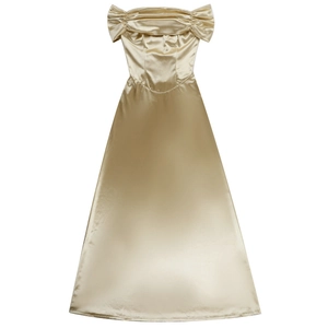 Detail of champagne gold satin off-shoulder dress with elegant pleated neckline and silk texture