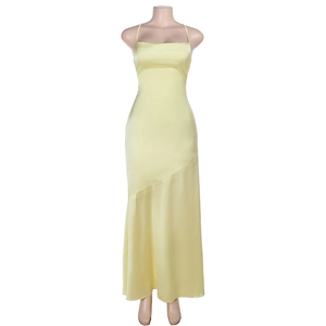 Detail of light yellow satin dress showing thin straps and sleek asymmetrical cut