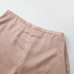 Detail of satin fabric waistband featuring lace butterfly embroidery and invisible zipper