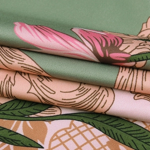 Detail of elegant satin floral print fabric with subtle shimmer and a smooth silk-like texture