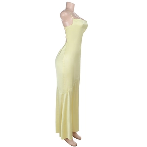 Detail of light yellow satin dress showing side slim fit and fishtail hem drape