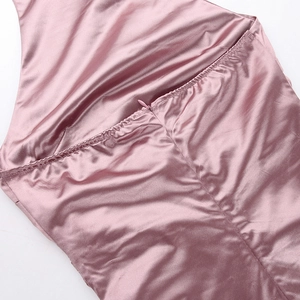 Detail of pink satin dress showing invisible zipper and elastic shirring craftsmanship