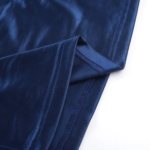 Detailed view of dark blue glossy fabric with double-needle stitching and finished edges