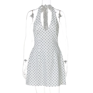 Detail of the halter neck tie and deep V-neckline on this white polka dot mini dress