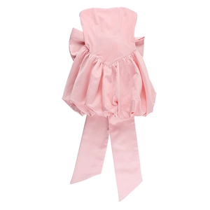 Detailed back view of light pink strapless dress with oversized bow and long ribbons
