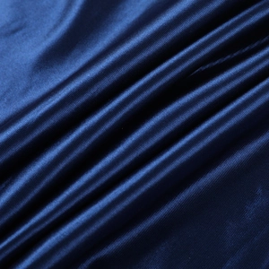 Close-up of deep blue satin fabric showing smooth texture and elegant light reflection