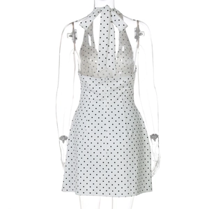 Detail of the halter tie back with a large bow on the black polka dot mini dress