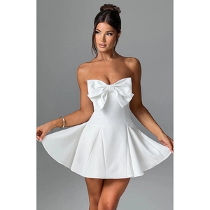 Detail of the large white bow on the strapless dress with a pleated A-line skirt