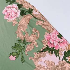 Detailed macro shot of sage green floral fabric with pink peony and baroque scroll patterns