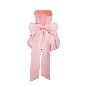 Pink satin tube top dress featuring back cross lacing and a large decorative bow detail