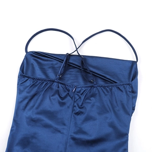 Detail of dark blue satin top featuring adjustable crisscross straps and invisible zipper