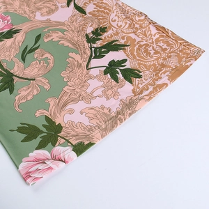 Detail of A-line dress hem featuring pink floral and baroque gold paisley patterns