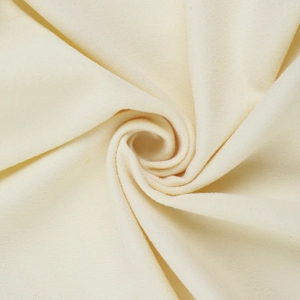 Close-up detail of soft cream-colored hollow knit fabric texture and premium weaving structure