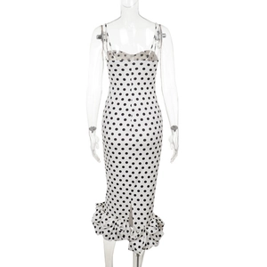 Back view of a white polka dot fishtail dress featuring elegant ruffled mermaid hemline