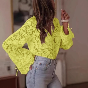 Detail showing neon yellow floral lace embroidery and sleeve tie-up design on the blouse