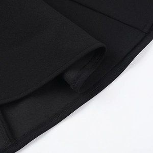 Detailed close-up showing the precise stitching and edge seam of black A-line dress