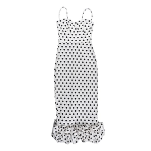 Close-up of elegant fishtail ruffle hem on white polka dot off-shoulder dress