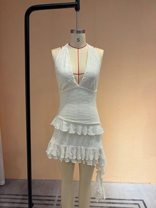 White halter neck dress with deep V-neck and tiered ruffle skirt on mannequin display