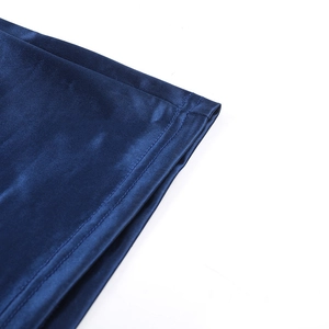 Detail of dark blue silk fabric showing precise double-needle stitching on the garment hem