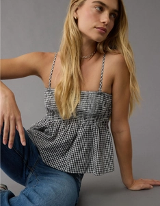 Detail of black and white gingham smocked camisole with adjustable straps and ruffled hem