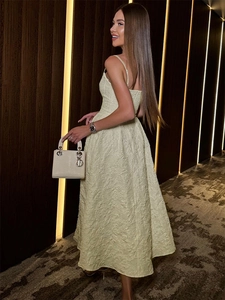 Detailed back view of a light yellow embossed jacquard strap dress with an A-line skirt
