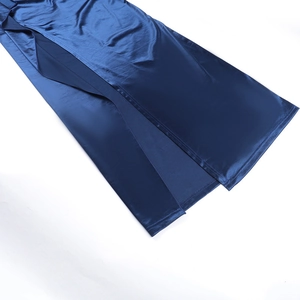 Detailed close-up of dark blue satin dress showing smooth fabric texture and side slit