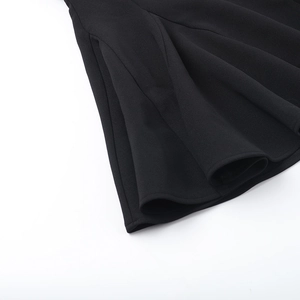 Detail view of the black pleated hem with fine stitching on an A-line evening dress