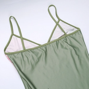 Detail of olive green dress with thin spaghetti straps and delicate floral pattern