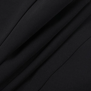 Detailed macro view of the premium black woven fabric texture and structured fold