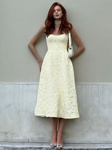 Detail of light yellow jacquard sleeveless midi dress with floral texture and square neck