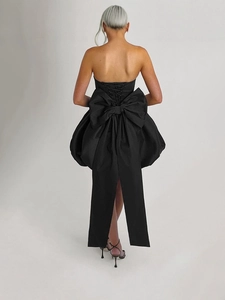 Elegant black strapless evening gown featuring large back bow and corset lacing detail