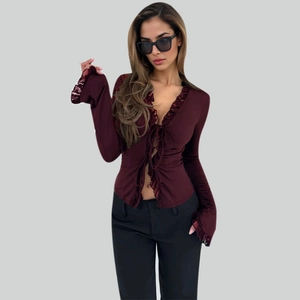 Detail of burgundy tie-front top featuring elegant lace trim on cuffs and V-neckline