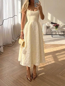 Close-up of ivory floral jacquard fabric and waist detail on an A-line midi dress