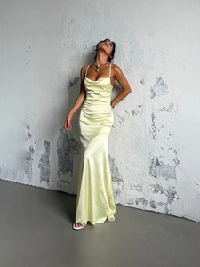 Elegant champagne satin maxi dress with thin straps and ruffled waist in a sleek fishtail cut