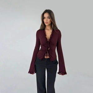 Detail of wine red chiffon top with V-neck lace trim and elegant criss-cross lace-up design
