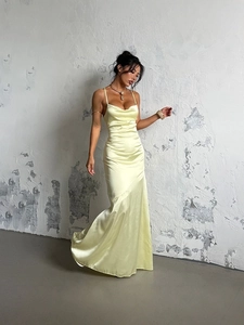 Elegant light yellow satin maxi dress with thin straps and a draped neckline silhouette