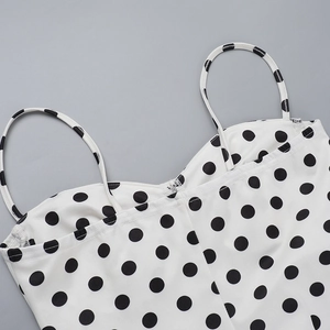 Close-up of a white polka dot dress with spaghetti straps and a sweetheart neckline