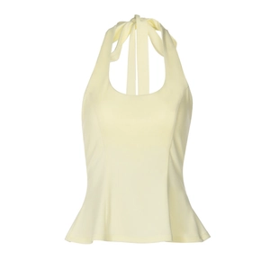 Detailed close-up of light yellow halter top with ruffle peplum hem and tied neck